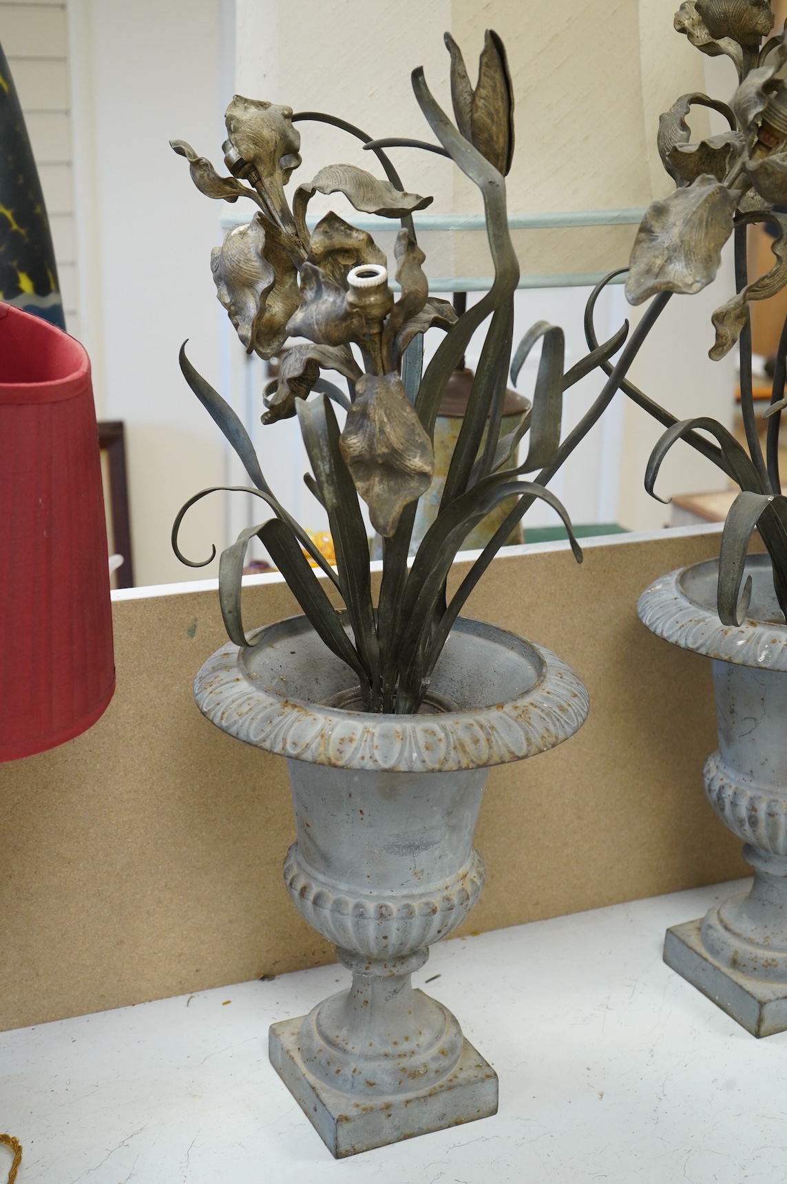 A pair of cold painted bronze floral lamps with painted cast iron campagna urns, 76cm high